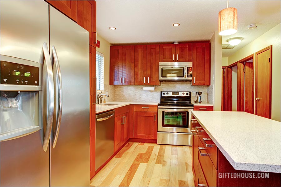 Cherry wood cabinets with white countertops